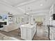 Open concept kitchen with white cabinets, granite countertops, and island that overlooks living room at 1503 Brooksland Pl, Waxhaw, NC 28173