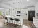 Modern kitchen with white cabinets, granite countertops, and a large island with seating at 1503 Brooksland Pl, Waxhaw, NC 28173