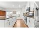 Modern kitchen with white cabinets, granite countertops, and stainless steel appliances at 1554 Kee Ct, Charlotte, NC 28203