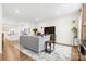 Living room with hardwood floors, gray couch, and large flat screen TV at 1554 Kee Ct, Charlotte, NC 28203