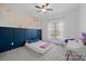 Bedroom with a floral wall mural and built-in desk at 162 Ravencrest Dr, Statesville, NC 28625