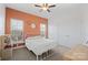 Bedroom with a metal bed frame and orange accent wall at 162 Ravencrest Dr, Statesville, NC 28625