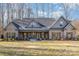 Brick home with gray metal roof, shutters, and a covered porch at 200 Barra Dr, Waxhaw, NC 28173