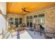 Relaxing covered patio with seating area and glass doors at 200 Barra Dr, Waxhaw, NC 28173