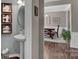 View of dining room from powder room, showing farmhouse table and wood floors at 2056 Angel Oak Dr, Fort Mill, SC 29715