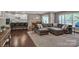 Spacious living room featuring hardwood floors, a large sectional sofa, and an open concept layout at 2056 Angel Oak Dr, Fort Mill, SC 29715