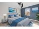 Spacious bedroom with ceiling fan, window, and blue accent wall at 2146 S Main St, Kannapolis, NC 28081