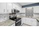 Kitchen with white cabinets, granite countertops and tile backsplash at 2146 S Main St, Kannapolis, NC 28081