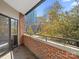 Private balcony with city views and brick detailing at 224 N Poplar St # 22, Charlotte, NC 28202