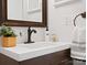 Modern bathroom vanity with dark brown cabinets and a white countertop at 224 N Poplar St # 22, Charlotte, NC 28202