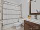 Clean bathroom with shower/tub combo, updated vanity, and tiled floors at 224 N Poplar St # 22, Charlotte, NC 28202