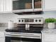 Stainless steel range with modern controls at 224 N Poplar St # 22, Charlotte, NC 28202