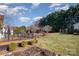 Spacious backyard with a deck, landscaping, and a large grassy area at 2241 Londonderry Dr, Gastonia, NC 28056