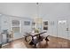 Dining area with hardwood floors, farmhouse table, and access to backyard at 2328 Barry St, Charlotte, NC 28205