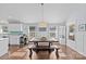 Bright dining area with farmhouse table and bench, hardwood floors, and large windows at 2328 Barry St, Charlotte, NC 28205