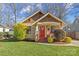 Craftsman style home with red door, landscaping, and a well-maintained lawn at 2328 Barry St, Charlotte, NC 28205