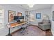 Functional home office with a standing desk, comfortable chair, and built-in shelving at 2328 Barry St, Charlotte, NC 28205