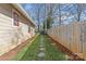 Landscaped side yard with stone pathway and wood fence at 2328 Barry St, Charlotte, NC 28205