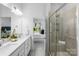 Bright bathroom with double vanity, modern fixtures, and a glass-enclosed shower visible from vanity at 3113 Beacon Heights Rd, Indian Land, SC 29707