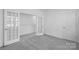 Spacious room with plush carpeting, neutral walls, and stylish French doors at 3113 Beacon Heights Rd, Indian Land, SC 29707