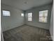 Well-lit bedroom with large windows, neutral carpeting, and ample space for furniture arrangements at 3113 Beacon Heights Rd, Indian Land, SC 29707