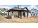 Exterior view of a community clubhouse showcasing a modern design with stone accents, columns, and a covered entrance at 3113 Beacon Heights Rd, Indian Land, SC 29707