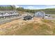 Aerial view featuring a clubhouse, streetscape, and townhomes within a new residential development at 3113 Beacon Heights Rd, Indian Land, SC 29707
