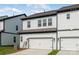 Townhome featuring neutral siding, a dark roof, and a two-car attached garage at 3113 Beacon Heights Rd, Indian Land, SC 29707