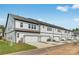 Row of townhomes with light siding, multiple windows, and attached two car garages at 3113 Beacon Heights Rd, Indian Land, SC 29707
