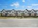 Street view of townhomes with manicured lawns and landscaping at 3113 Beacon Heights Rd, Indian Land, SC 29707