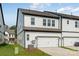 Attractive townhome exterior with white siding, dark roof, and attached garage at 3113 Beacon Heights Rd, Indian Land, SC 29707