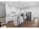 Bright kitchen featuring white cabinets, stainless appliances, island with seating, and hardwood floors at 3113 Beacon Heights Rd, Indian Land, SC 29707