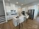 Bright kitchen featuring white cabinets, stainless steel appliances, a center island, and elegant pendant lighting at 3113 Beacon Heights Rd, Indian Land, SC 29707
