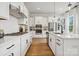 Modern white kitchen with stainless steel appliances and a large island at 3113 Beacon Heights Rd, Indian Land, SC 29707