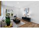Bright living room featuring a comfortable sofa, modern decor, and ample natural light at 3113 Beacon Heights Rd, Indian Land, SC 29707