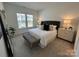 Serene main bedroom with plush carpeting, neutral tones, a comfortable bed, and ample natural light at 3113 Beacon Heights Rd, Indian Land, SC 29707