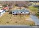 A home's setting is captured in this aerial shot, highlighting the lush green lawn, nearby buildings and neighborhood at 3416 Polkville Rd, Shelby, NC 28150