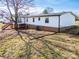 Exterior home elevation showing a deck and white siding, complemented by a well-maintained backyard at 3416 Polkville Rd, Shelby, NC 28150