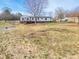 Wide backyard and exterior elevation with a deck and white siding for this attractive single-story home at 3416 Polkville Rd, Shelby, NC 28150