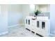 Stylish bathroom featuring double sink vanity, modern black and white backsplash and marble look floors at 3416 Polkville Rd, Shelby, NC 28150