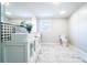 Bathroom featuring double sink vanity, marble-look floors, modern backsplash, and a toilet at 3416 Polkville Rd, Shelby, NC 28150