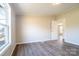 Inviting bedroom with hardwood floors and natural light pouring in through the window at 3416 Polkville Rd, Shelby, NC 28150