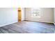 Bedroom with gray vinyl floors, neutral walls, closet and a window with natural light at 3416 Polkville Rd, Shelby, NC 28150