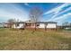 Inviting single-story home with a cozy porch, enhanced by a well-manicured lawn and mature trees at 3416 Polkville Rd, Shelby, NC 28150