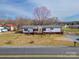 Exterior showcasing a well-maintained single-story home with a welcoming front porch, lush lawn, and a clear view of the neighborhood at 3416 Polkville Rd, Shelby, NC 28150