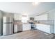 Bright kitchen featuring stainless appliances, white cabinetry, and black and white backsplash at 3416 Polkville Rd, Shelby, NC 28150