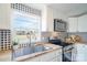 Bright kitchen with stainless steel appliances, butcher block countertops, and stylish blue-and-white patterned backsplash at 3416 Polkville Rd, Shelby, NC 28150