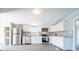 Bright kitchen featuring stainless appliances, white cabinetry, and black and white backsplash at 3416 Polkville Rd, Shelby, NC 28150