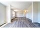 Living room featuring gray vinyl floors and neutral walls with plenty of natural light at 3416 Polkville Rd, Shelby, NC 28150