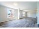 Bright living room with sleek gray vinyl floors and neutral walls with views of the outdoors at 3416 Polkville Rd, Shelby, NC 28150